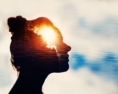 Silhouette of a woman's profile with a bright sun shining in her mind, surrounded by clouds and water, symbolizing introspection and creativity.